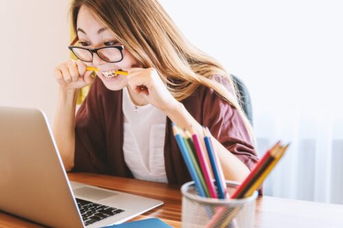 Erwachsene Frau arbeitet konzentriert mit Laptop beim Lernen